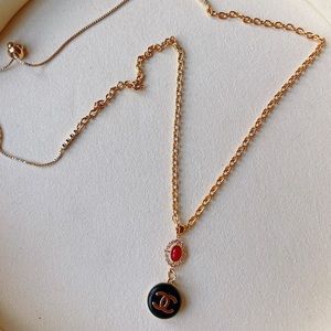 Chanel black and gold logo necklace